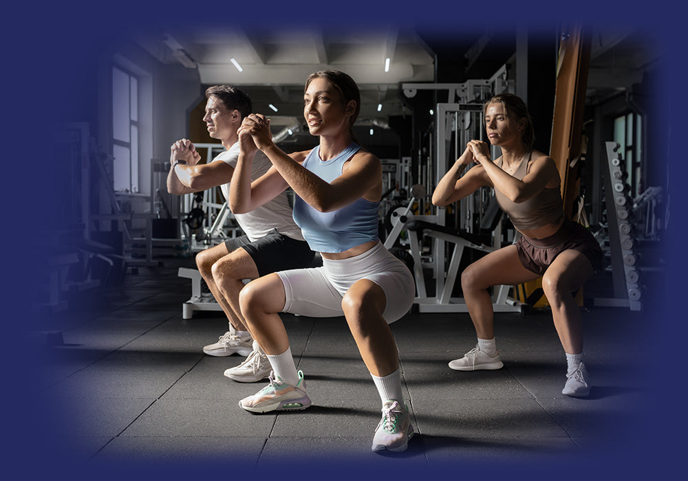 Group fitness class performing squats, boosting wellness with Pro-Fit's lifestyle ethos.