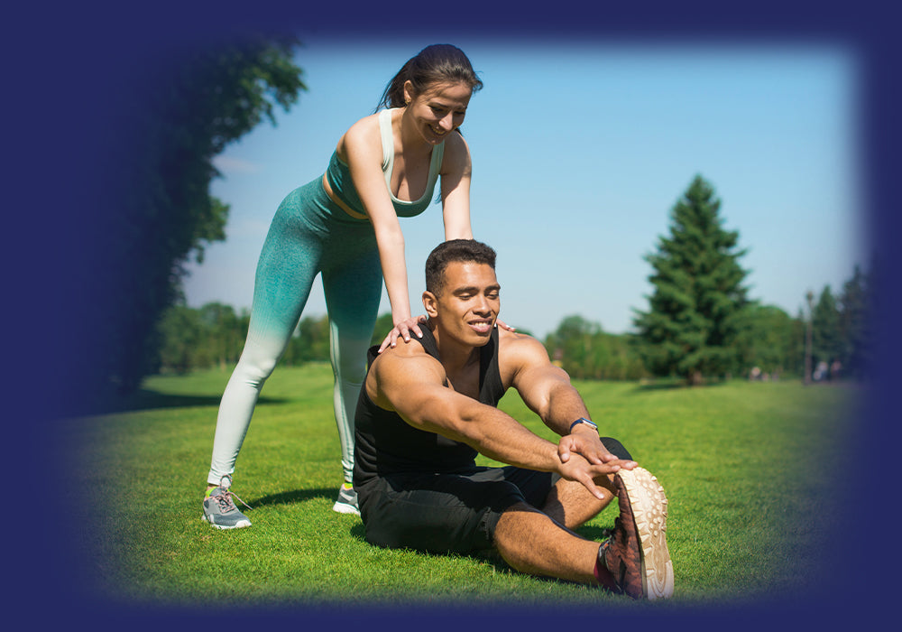 Couple enjoying outdoor stretching exercises, promoting Pro-Fit's active lifestyle
