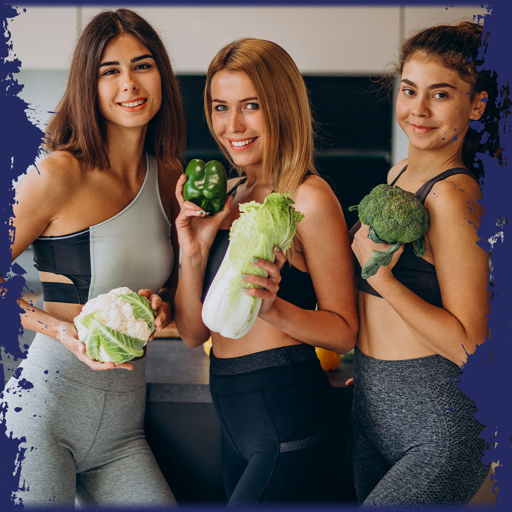 A group of women in fitness gear holding vegetables