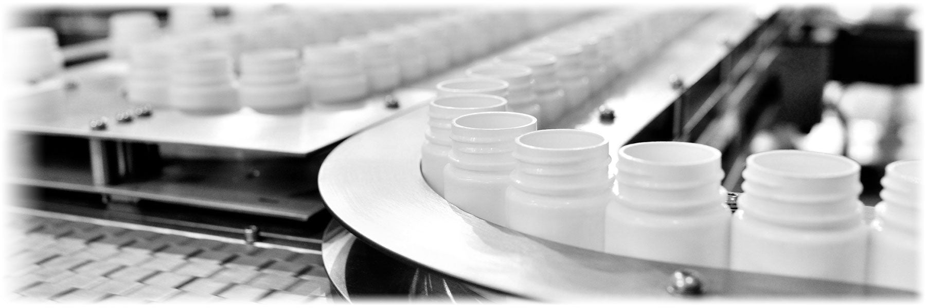 Rows of white pots on a conveyor belt
